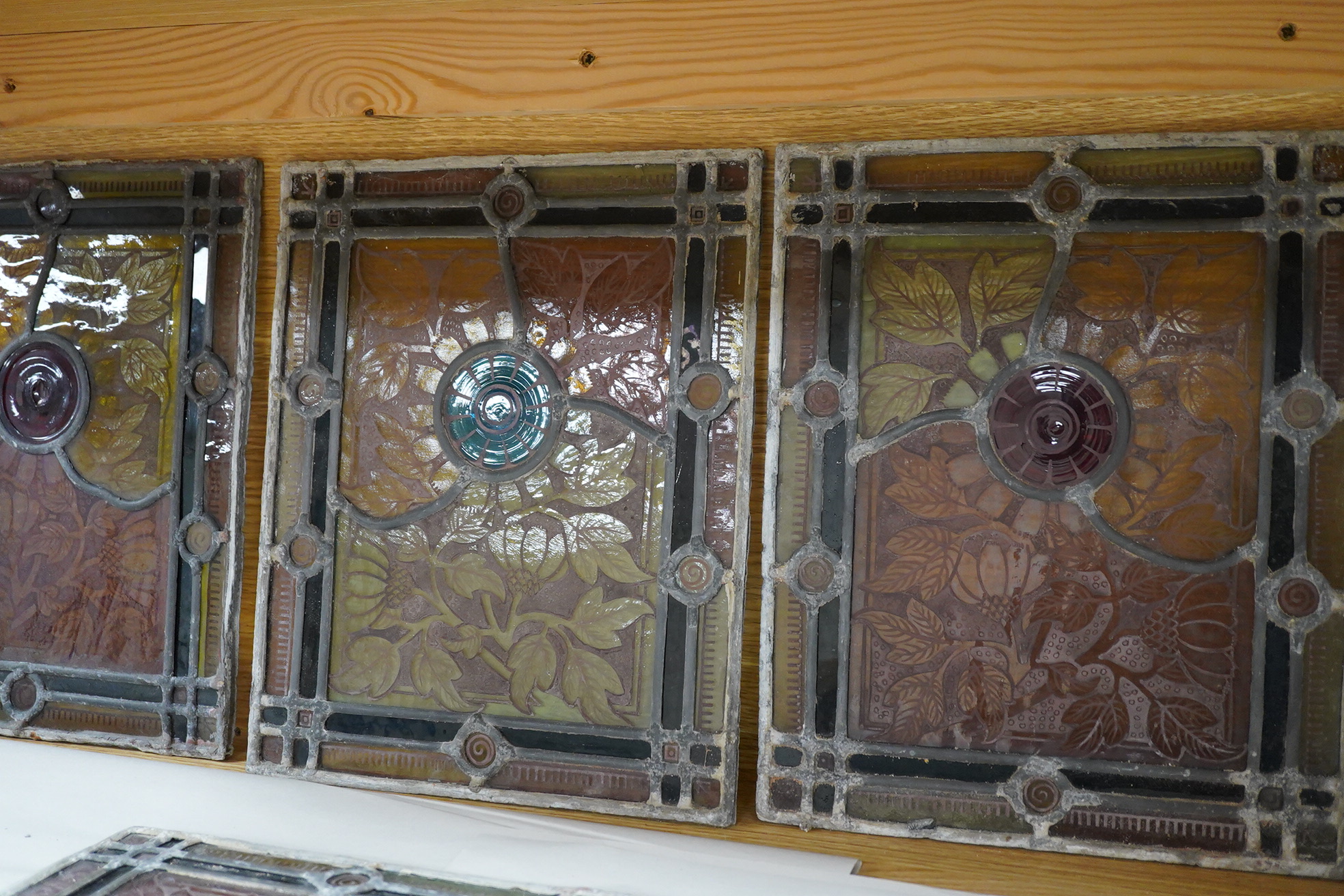 A set of eight late 19th century leaded stained glass panels, 23cm x 28cm